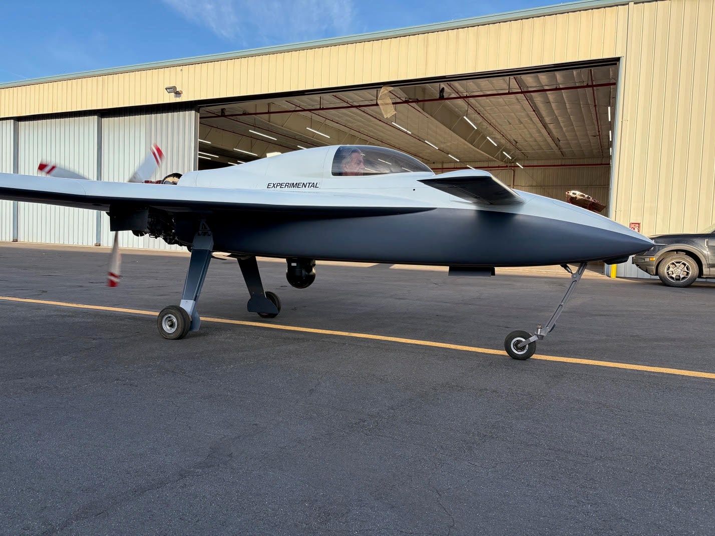Mobius optionally piloted testbed taxiing past a hangar at golden hour with an MX-10 sensor ball fitted