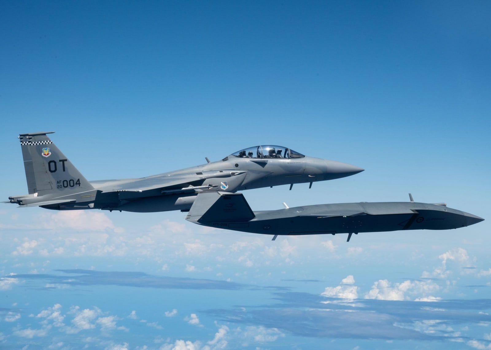 Air-to-air photograph of a fighter aircraft over the ocean during a joint exercise